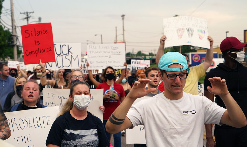 As the march moved forward, protesters raised their hands and shouted "Don't shoot" on Wednesday.